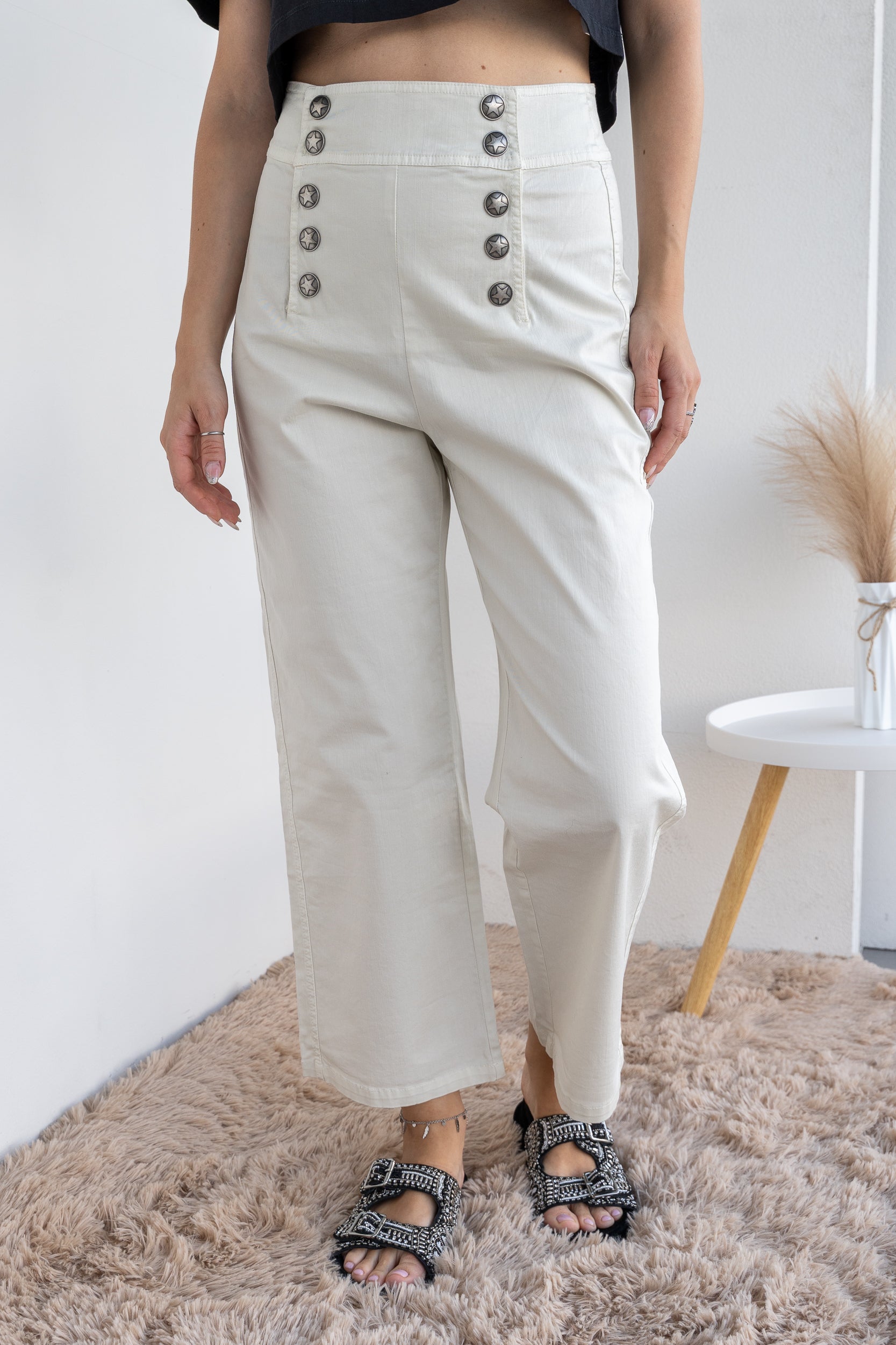 Trousers with double fastening