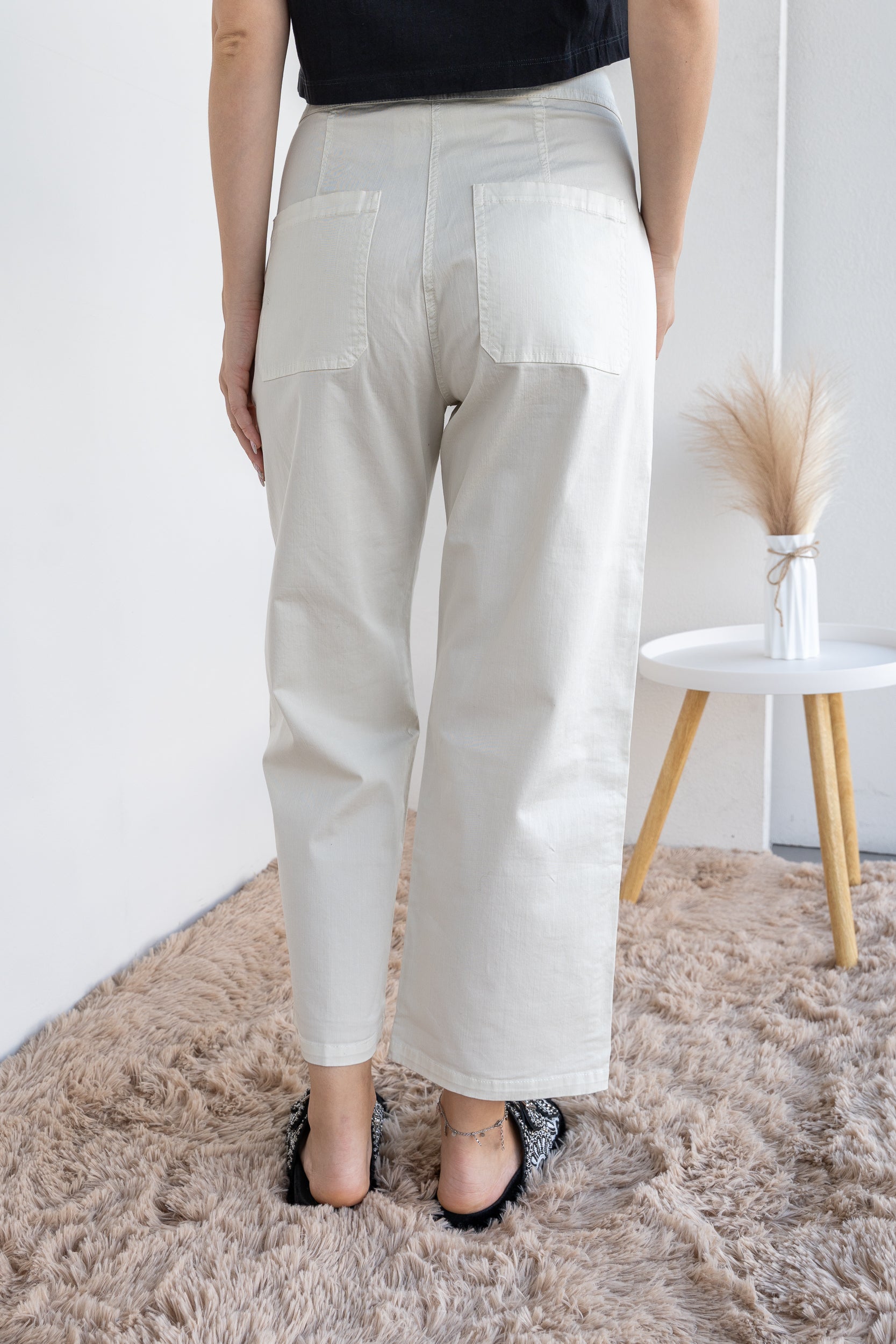 Trousers with double fastening